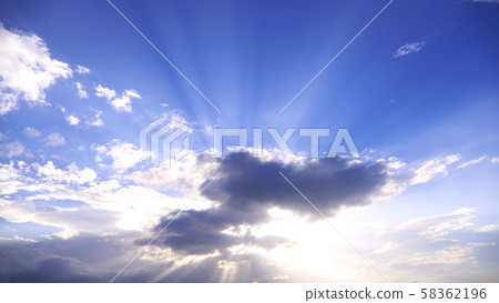 White clouds blocking the blue sky and the sun 58362196