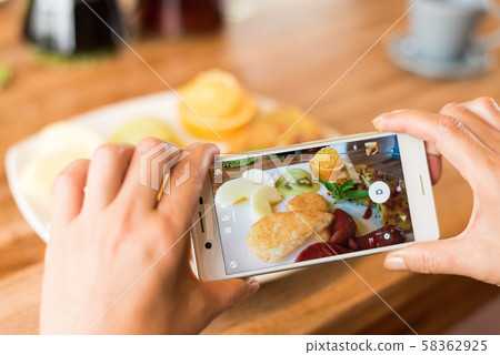 taking photo at breakfast 58362925