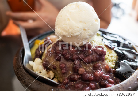 eating shaved ice with colorful dessert eating shaved ice with colorful dessert 58362957