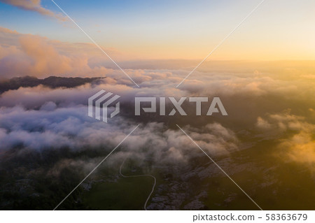 Picos de Europa in clouds during sundown Picos de Europa in clouds during sundown 58363679