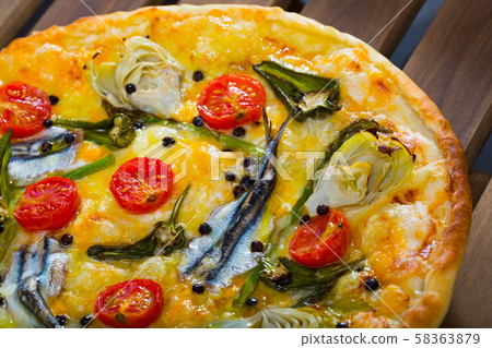 Pizza with anchovies, sun-dried tomatoes, artichokes, cheese Pizza with anchovies, sun-dried tomatoes, artichokes, cheese 58363879