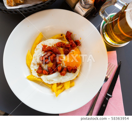 Top view of broken eggs with chistorra Top view of broken eggs with chistorra 58363954