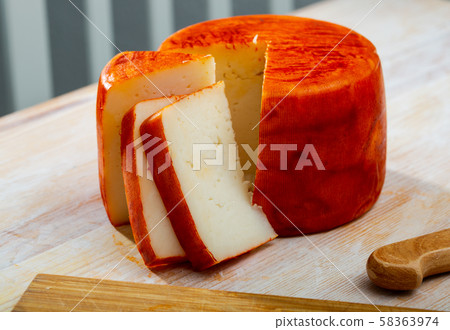 Tasty french goat cheese with pepper, slices at wooden desk 58363974