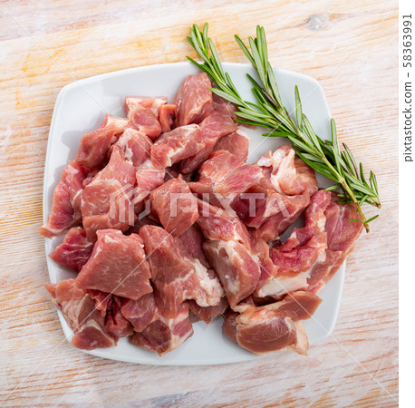 Raw pork neck meat cuts, top view on wooden background Raw pork neck meat cuts, top view on wooden background 58363991