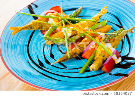 Battered sprats with creamy ginger sauce, tomatoes, balsamic 58364057