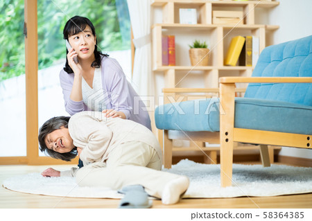 Mother and child who call an ambulance for a mother who has fallen suddenly 58364385
