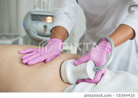 Belly cavitation at modern beauty clinic Belly cavitation at modern beauty clinic 58364410