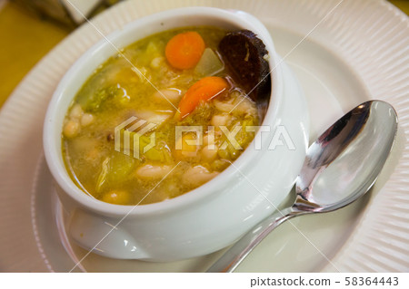 Bean's catalan soup with carrots and potatoes, served with black sausage Bean's catalan soup with carrots and potatoes, served with black sausage 58364443