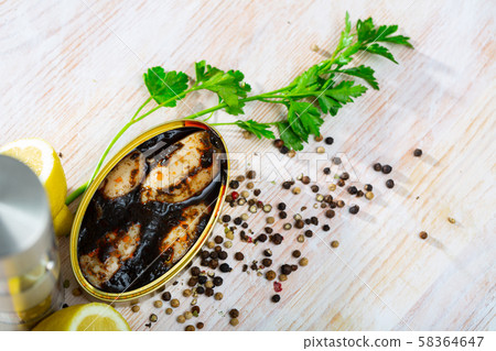 Marinated chipirones in ink with greens and lemon Marinated chipirones in ink with greens and lemon 58364647