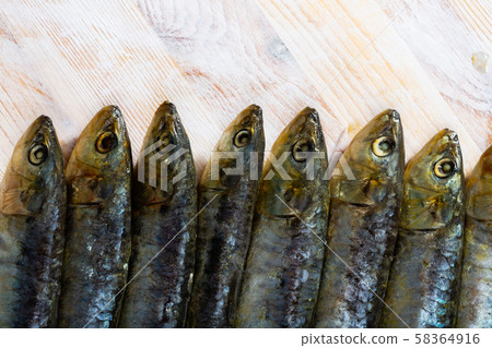 Marinated sardines on wooden table 58364916