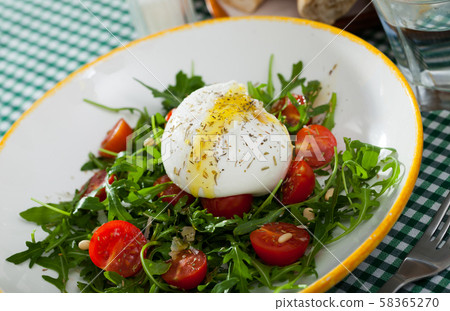 Image of salad with burrata italian cheese, arugula and cherry tomatoes 58365270