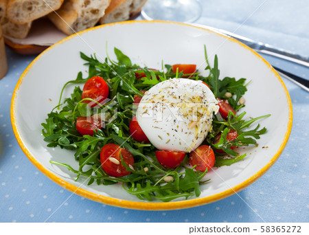 Salad with soft Burrata cheese Salad with soft Burrata cheese 58365272