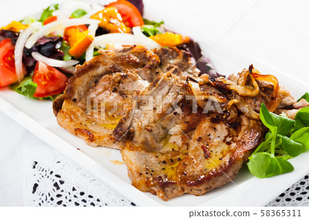 Fried pork loin with summer salad Fried pork loin with summer salad 58365311