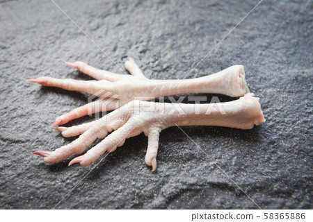 Chicken feet on black plate - Fresh raw chicken Chicken feet on black plate - Fresh raw chicken 58365886
