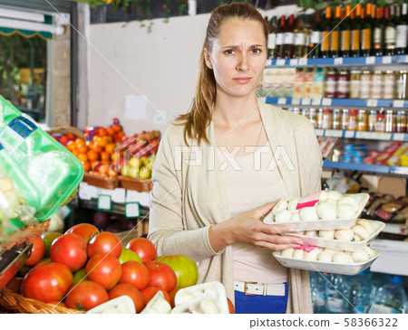Glad woman is standing with mushrooms Glad woman is standing with mushrooms 58366322