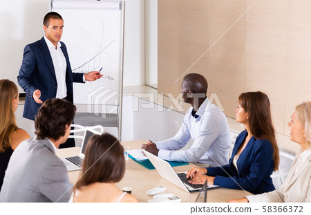 Man reading out report on meeting 58366372