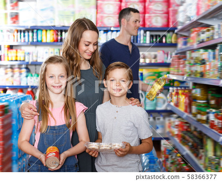 Cheerful mother and kids is holding products 58366377