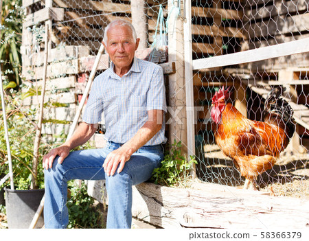 Older man near henhouse 58366379