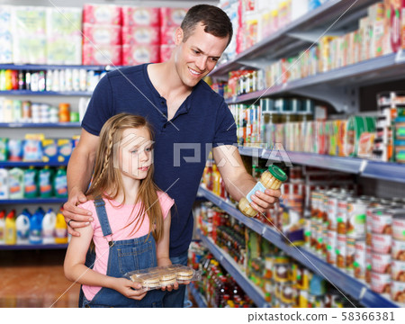 man and daughter purchasing food man and daughter purchasing food 58366381