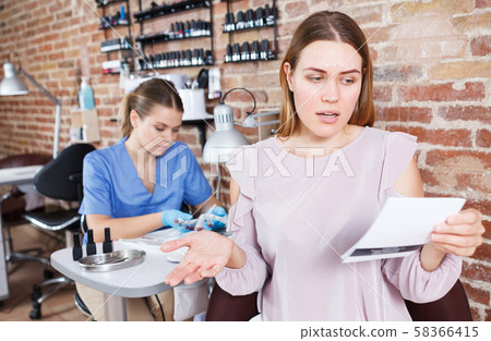 Unhappy girl client client not agree with chek in nail salon Unhappy girl client client not agree with chek in nail salon 58366415