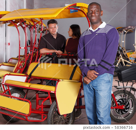 African-American pedicab driver offering rickshaw cycle tour African-American pedicab driver offering rickshaw cycle tour 58366716