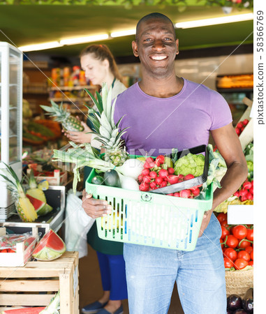 Smiling man is standing with basket Smiling man is standing with basket 58366769