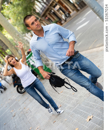 Bandit man running with handbag after stole this from emotional female Bandit man running with handbag after stole this from emotional female 58367034
