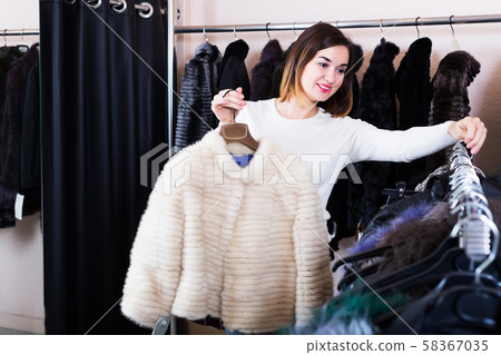 Girl choosing mink jacket 58367035