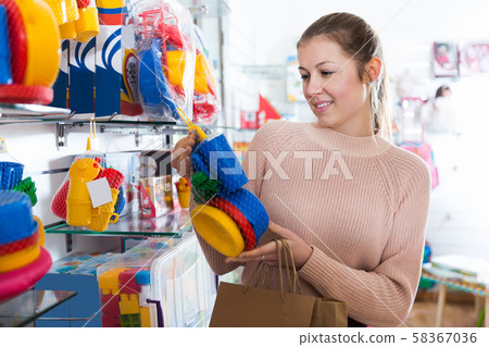 female choosing children's plastic toys female choosing children's plastic toys 58367036