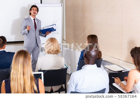 Man presenting business project to coworkers 58367164