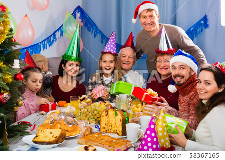 Large family exchanging gifts during Christmas dinner 58367165