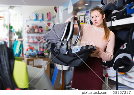 consumer with infant's car cradle 58367237