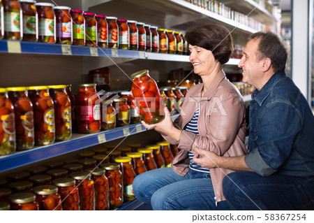 Husband and wife selecting a salted tomatoes 58367254