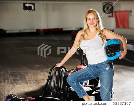 Woman standing near go-kart cars Woman standing near go-kart cars 58367307