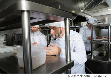 Staff of restaurant with head chef working 58367679