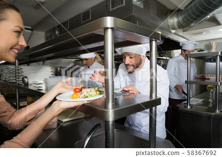 Staff of restaurant with head chef working 58367692