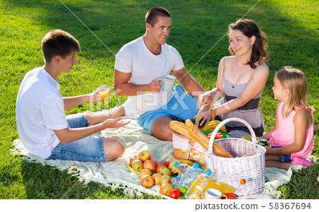 Smiling woman with family at picnic 58367694