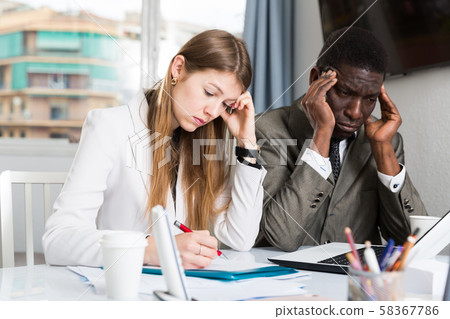Upset coworkers working together 58367786