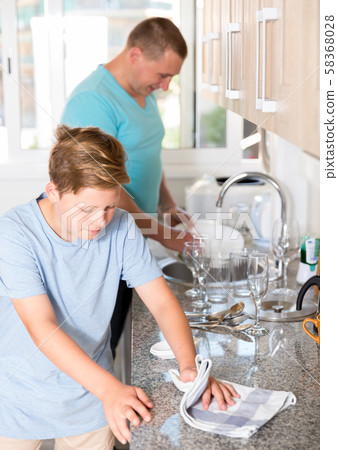 Man with his son are washing dishes on the kitchen Man with his son are washing dishes on the kitchen 58368028