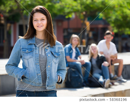 Cheerful girl smiling and standing Cheerful girl smiling and standing 58368196
