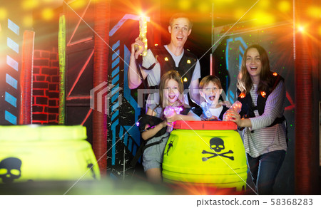 Kids and adults in beams on lasertag arena 58368283