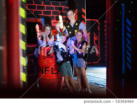 Family posing with laser pistols Family posing with laser pistols 58368464
