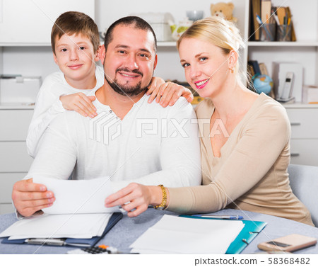 Friendly family with papers Friendly family with papers 58368482