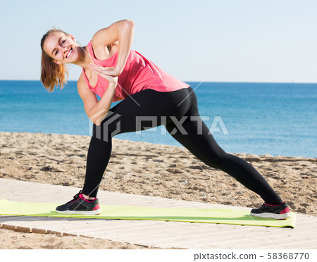 woman working out in beach woman working out in beach 58368770