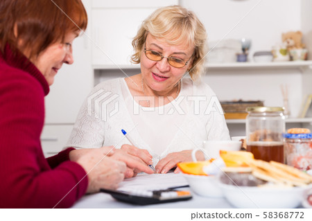 Cheerful elderly women with documents Cheerful elderly women with documents 58368772