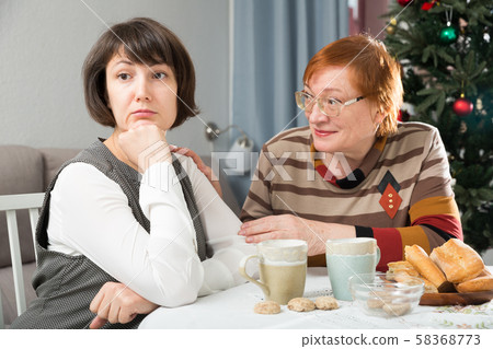 Quarrel of mother and daughter at the Christmas table Quarrel of mother and daughter at the Christmas table 58368773