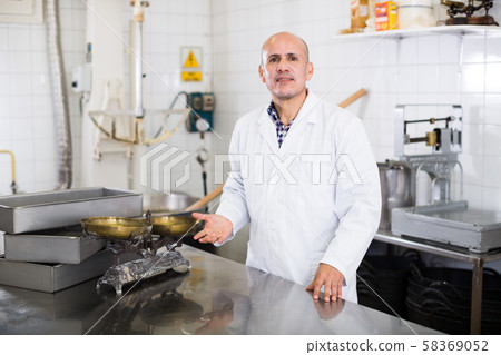 Adult male standing in production workshop Adult male standing in production workshop 58369052