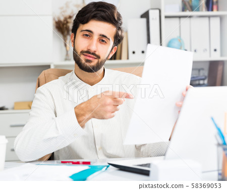 Office worker holding paper with contract Office worker holding paper with contract 58369053
