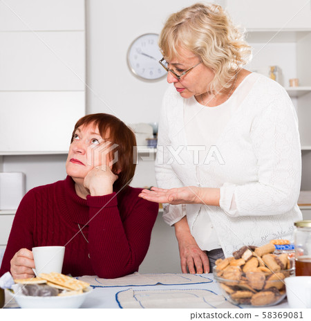 Pensioners females quarreling at kitchen Pensioners females quarreling at kitchen 58369081