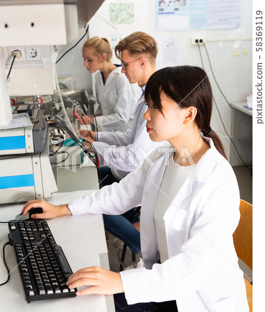 Chinese female student working in lab 58369119